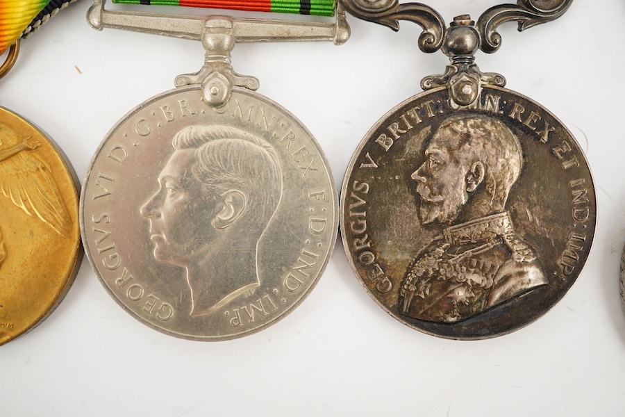 A medal group comprising of a Meritorious Service medal, a 1939 to 1945 Defence Medal, and a First World War trio awarded to 3824 SJT. F.W.G. Wakefield. R.F.A., together with a Delhi Durbar Medal 1911, crudely engraved t